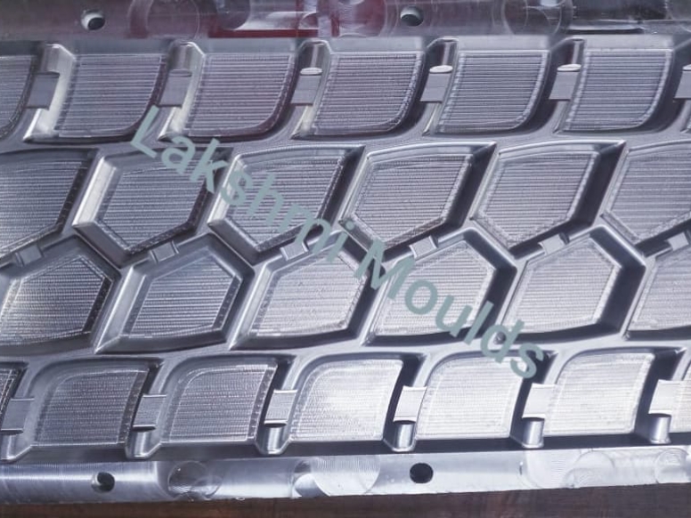 Precured tread rubber mould design